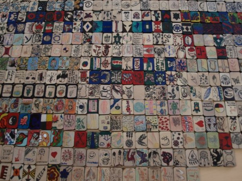 Image of a mosaic of hundreds of tiles that represent students who lost their lives in Indian Residential Schools.