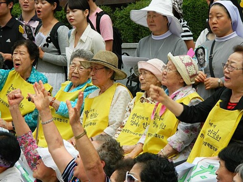 A group of comfort women rally in front of the Japanese Embassy in Seoul in August 2011 to demand justice from the Japanese government for the sexual slavery they experienced during World War II. (Claire Solery/Wikimedia)